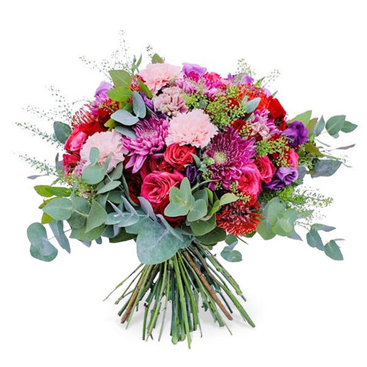 A mixed flower bouquet with white and pink carnations, chrysanthemums, spray roses.