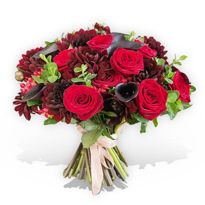 Flower bouquet with large red roses, dark pink calla lilies and red carnations