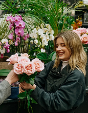 Florist holding a bouquet of roses
